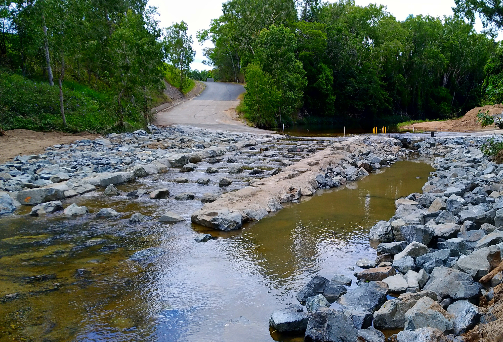 Lateral ridge rock ramp fishway built into the tailwater with low flow fish passage channel down the centre and high flow fish passage on both banks, Palm Tree Road, Sandy Creek, Queensland Photo by Matthew Moore