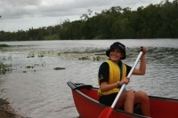 Child paddeling a canoe