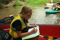 Child doing written work in canoe 2